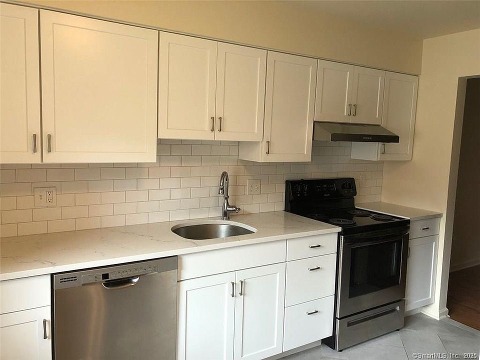 Newly renovated kitchen with quartz counters and stainless steel appliances.