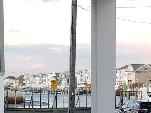 Zoomed-in bay view from the prior porch photo. This home is on the bay block, a few houses from the bay and about an 8 minute walk to the beach.