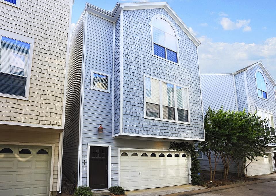 The shady driveway leads up to the private two car garage which offers additional storage space. To 