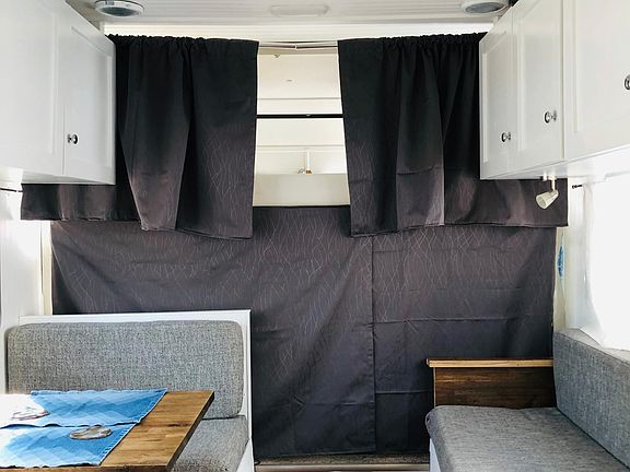 This shows eating area, sleeper couch, and tempurpedic mattress loft bed. Above shows the centrally located AC and heating unit.