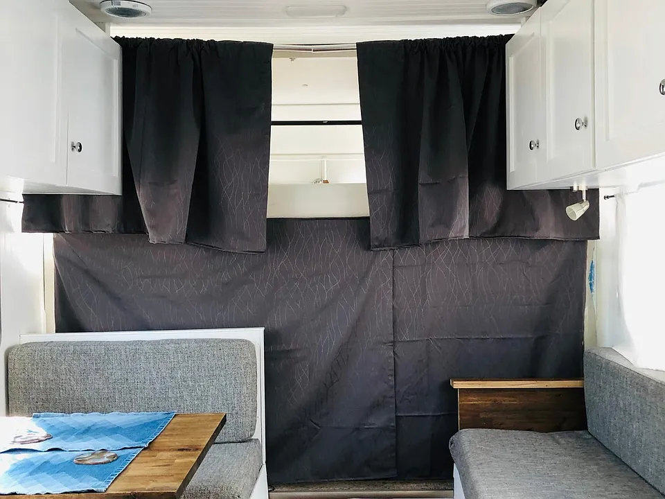 This shows eating area, sleeper couch, and tempurpedic mattress loft bed. Above shows the centrally located AC and heating unit.