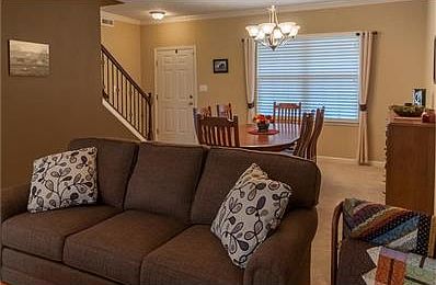 Entry into the home opens into the formal dining room. The home boasts natural light from the large windows throughout.