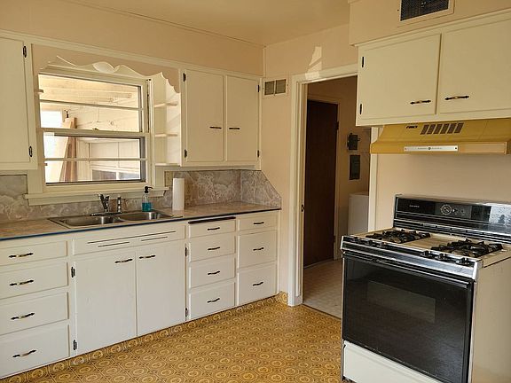 Kitchen looking into laundry