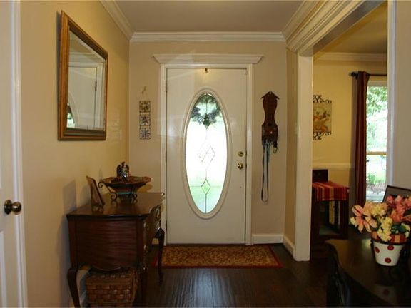 Front entry with hardwood flooring. Formal dining room to the right.