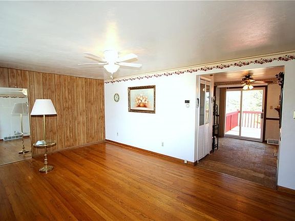 Beautiful Original Hardwood Floors in 18x12 Living Room w/ Ceiling Fan Light & Big Front Picture Window calling in the Natural L