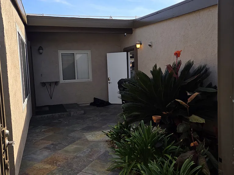 Front courtyard behind secured magnetic gate.
