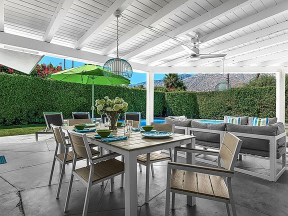 Enjoy al fresco dining in our charming outdoor area, complete with a spacious table perfect for gatherings. Savor meals under the stars, surrounded by lush landscaping, and unwind in the warm ambiance. Ideal for creating unforgettable memories!