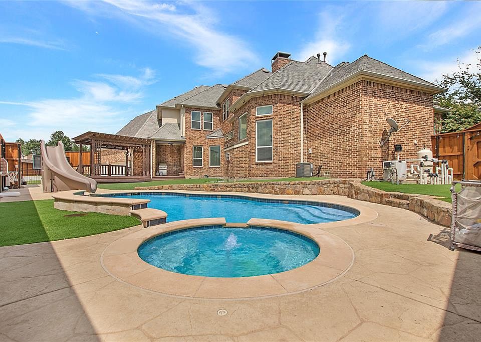 View of swimming pool with a water slide, a pergola, a patio, and a pool with connected hot tub