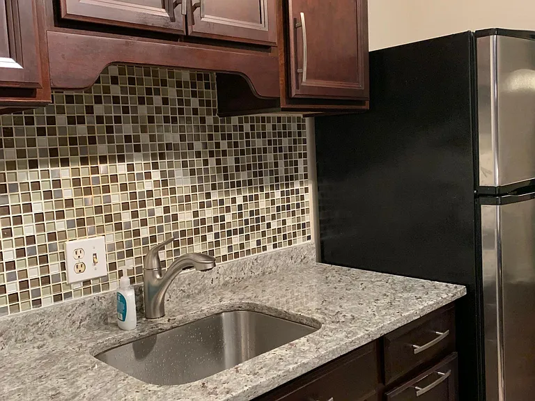 Kitchen with brand new granite counter top, sink and spotless faucet