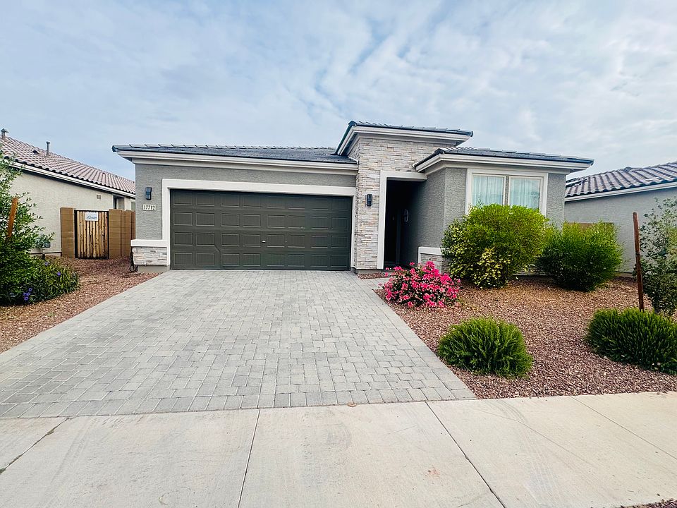 Front Exterior with upgraded stone elevation, paver driveway, and spacious 2-car garage