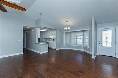 View of kitchen, dining area, and entry from living area