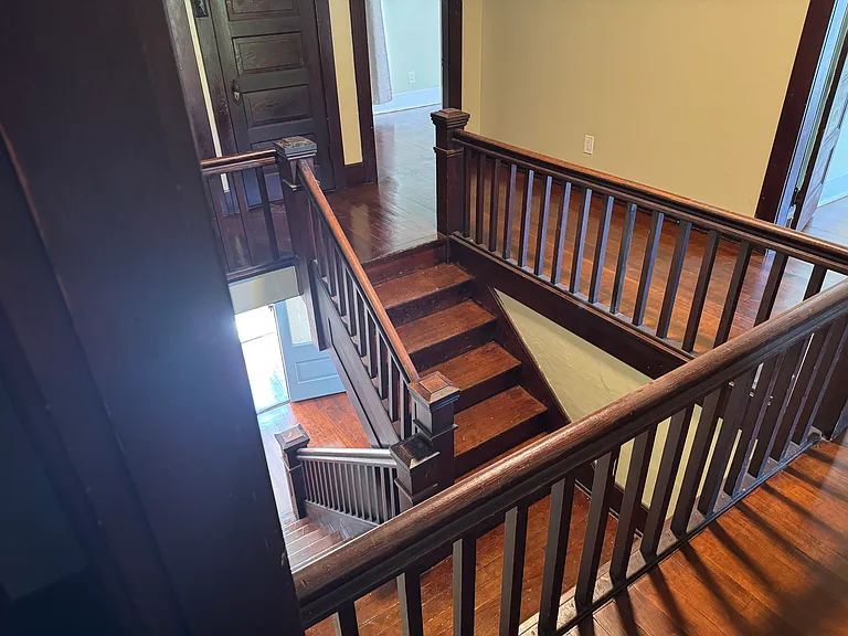 View down the grand staircase from the second floor landing to the front entry way.