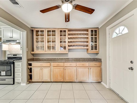 Great breakfast area with built in cabinets and wine rack.