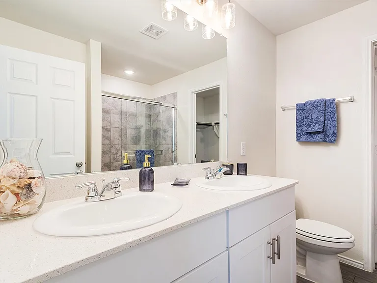 Dual vanity with integrated sinks and chrome fixtures