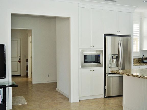 The far end door open to the 2 car garage.