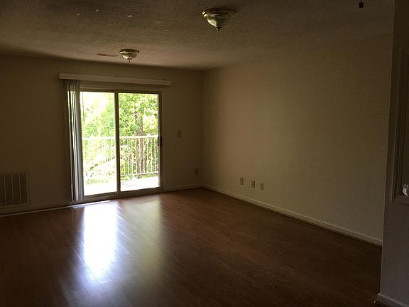 Smooth hardwood floors in living room; easy access balcony
