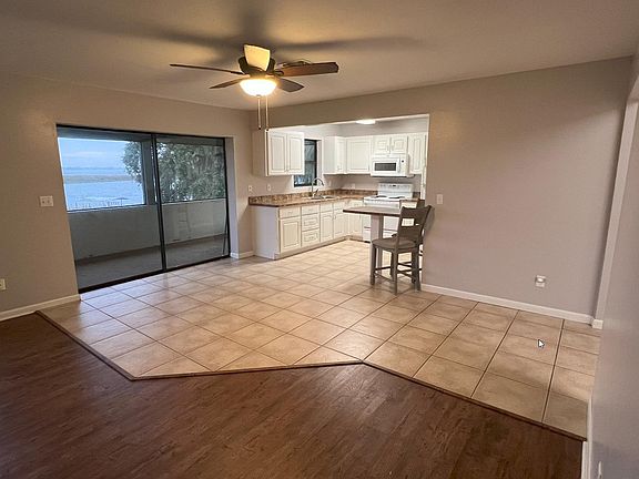 View from front door facing kitchen and out patio to lake