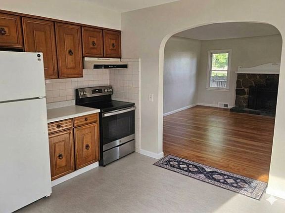 kitchen view looking into living room with fresh professional paint and freshly professional refinished hardwood floors