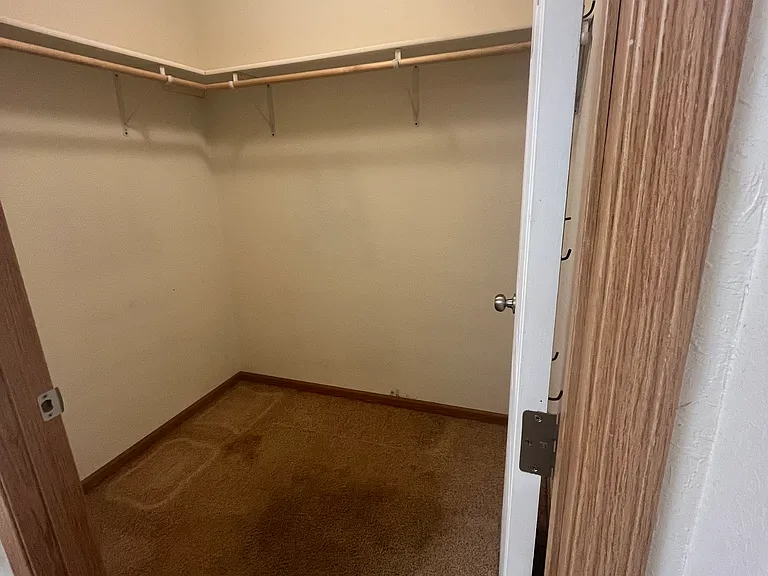 Spacious walk-in closets with metal breathable shelving for storage.