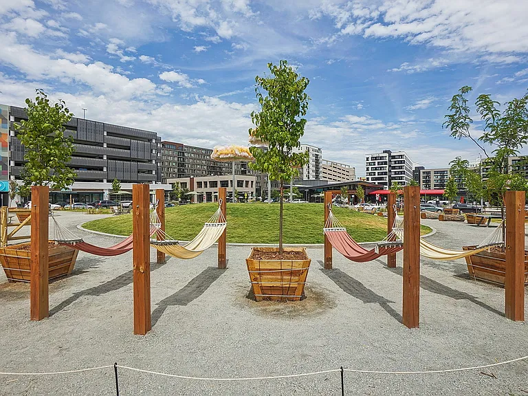 Inviting urban oasis featuring hammocks and lush greenery, set against modern architecture with vibrant urban life.