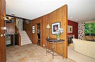 Patio. Shady rear patio boasts gorgeous rhododendron.