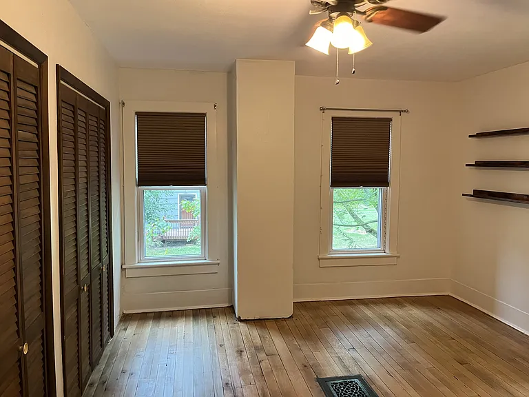 Large bedroom with 2 closets. Ceiling fan and refinished natural hardwood floors.