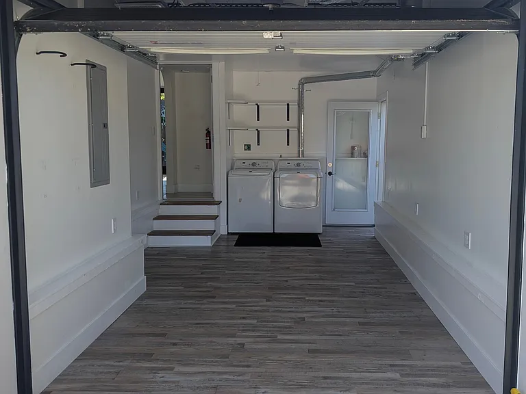 Garage doors open to a conditioned space that can be a playroom for the kids, extra office space or just a hobby room.