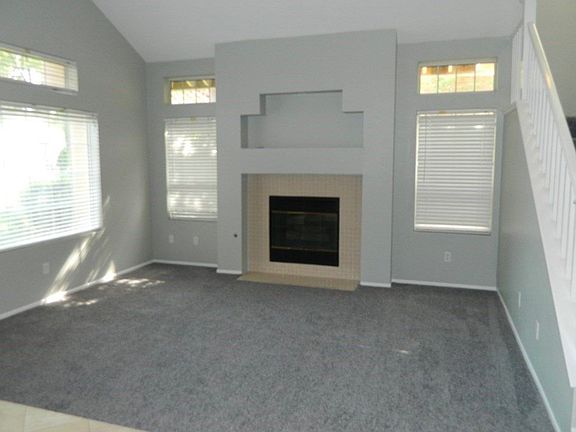 Step down formal living room with gas fireplace.