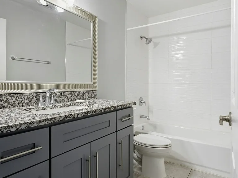 Master bath with soft close vanity, granite counter top, standing shower & ventilation fan