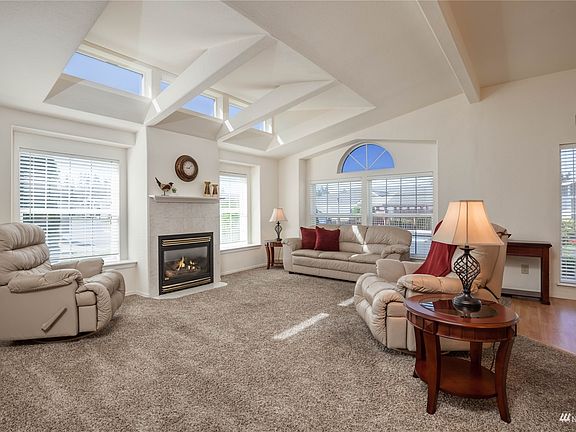 Living room has bright windows, gas fireplace>