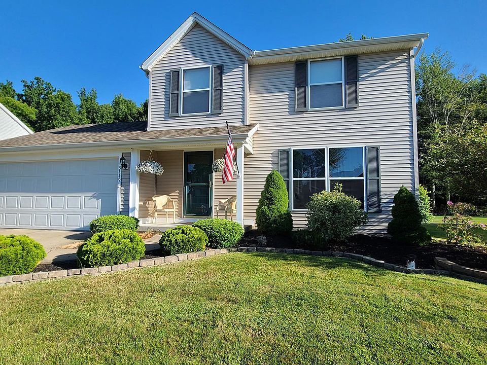 Street-view of house, 2-car garage, and porch