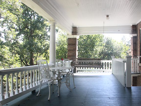 Neighbors' front porch swing and seating area. Front steps to the right.
