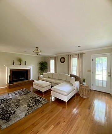 Elegant living room features brand new hardwood floors , warm pastel colors and interesting view to the expansive back patio and yard.