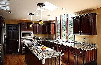 Remodeled kitchen with slab granite and stainless appliances