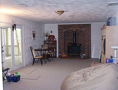 Lower family room with efficient wood stove.