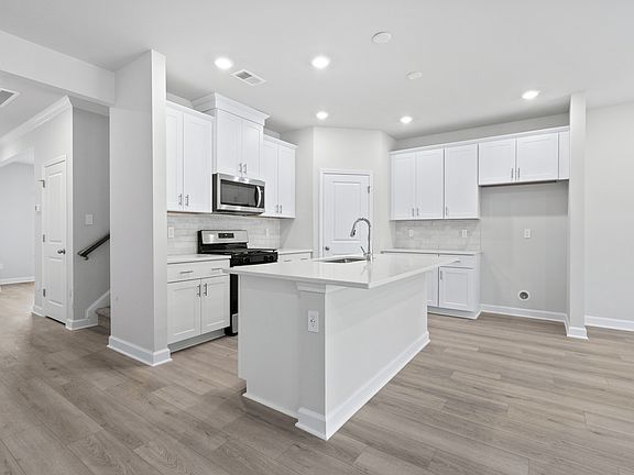 The stunning open-concept floorplan allows for easy flow between the kitchen and dining areas.