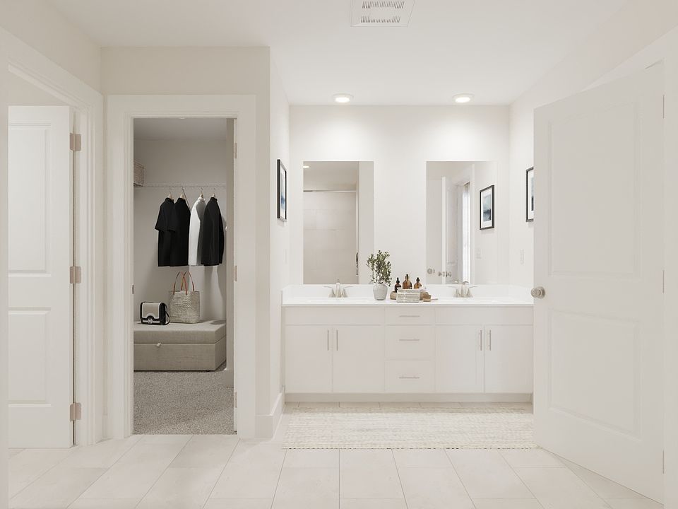 The primary bathroom offers dual vanity sinks and a walk-in shower.