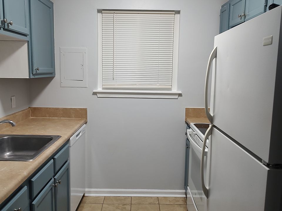 Galley kitchen with new dishwasher and vent fan.