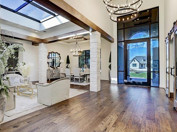 Enter through the massive steel and glass door to first experience this gorgeous home.