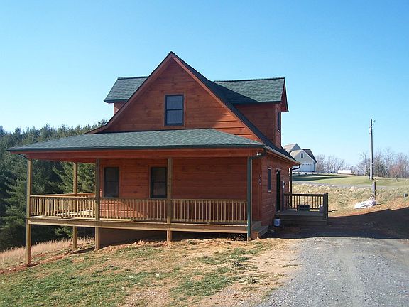 The large wrap around deck on this log sided home is the perfect place to enjoy the long range mountain views.