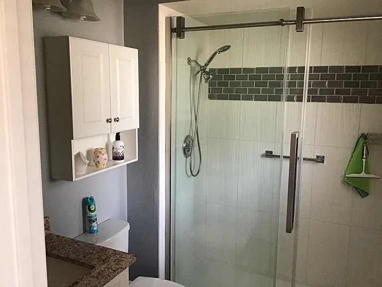 Master bathroom with tiled walls Walk in.