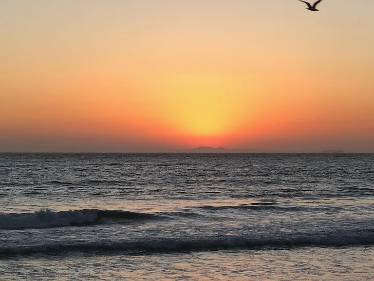Sunset walk on the beach 300-400 feet away from this apartment