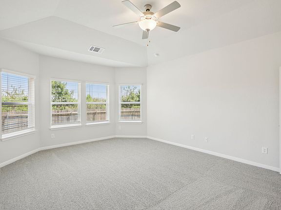 Enjoy some natural lighting in the primary bedroom with this bay window.