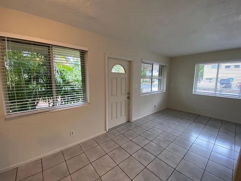 On left Dining area with north facing window that looks onto planted areas; then front door; then Large living room area, with north then east facing windows which looks unto your own private parking place. (2 Cars Deep)