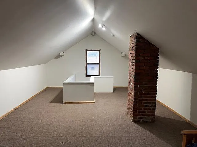 Other side of bonus space. Staircase leading to attic