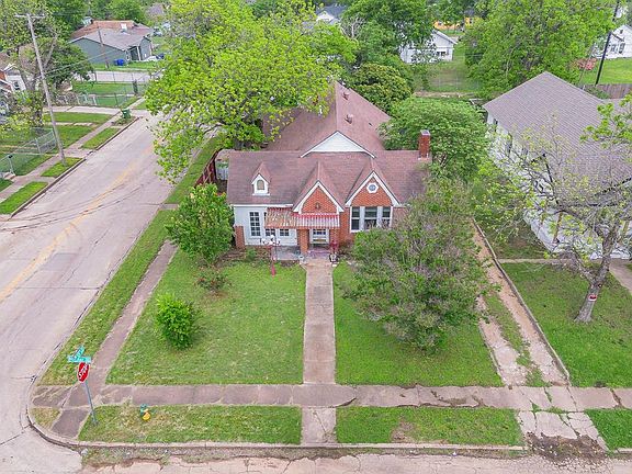 The property features a traditional architectural style with a prominent gabled roof and a brick chimney