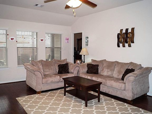Spacious family room offers wall of windows...
