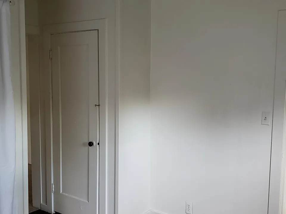 Bathroom located off entry, separate from bedroom/living area.