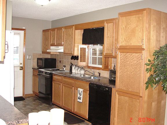 Black appliances, tile backsplash new floor & counters