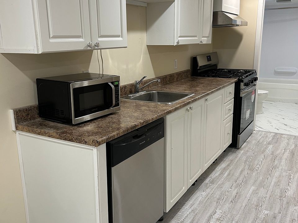 Kitchen includes microwave, dishwasher, gas range (stove and oven), fridge.